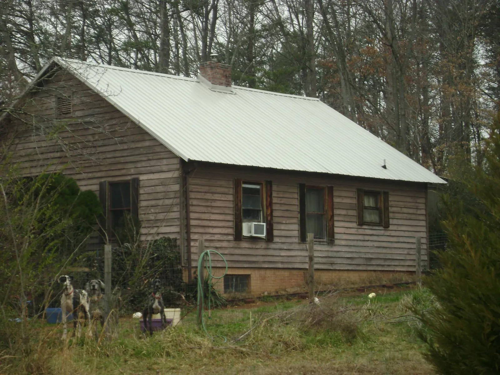 White metal roof on an old wood sided farmhouse, from a Metal Roof Installation job in Reevesville